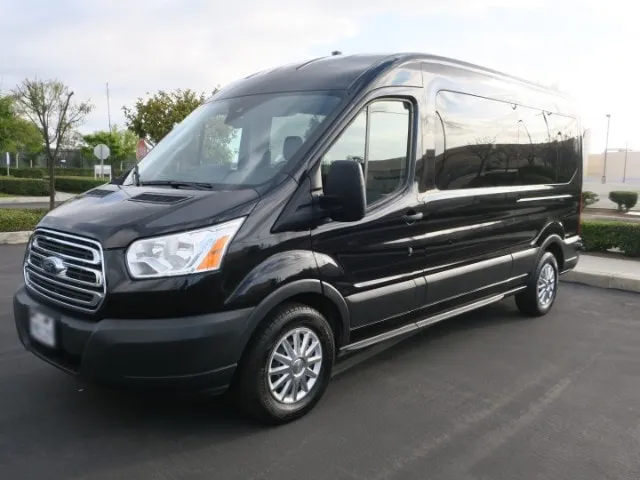 Black 10-passenger Ford Transit luxury conversion van