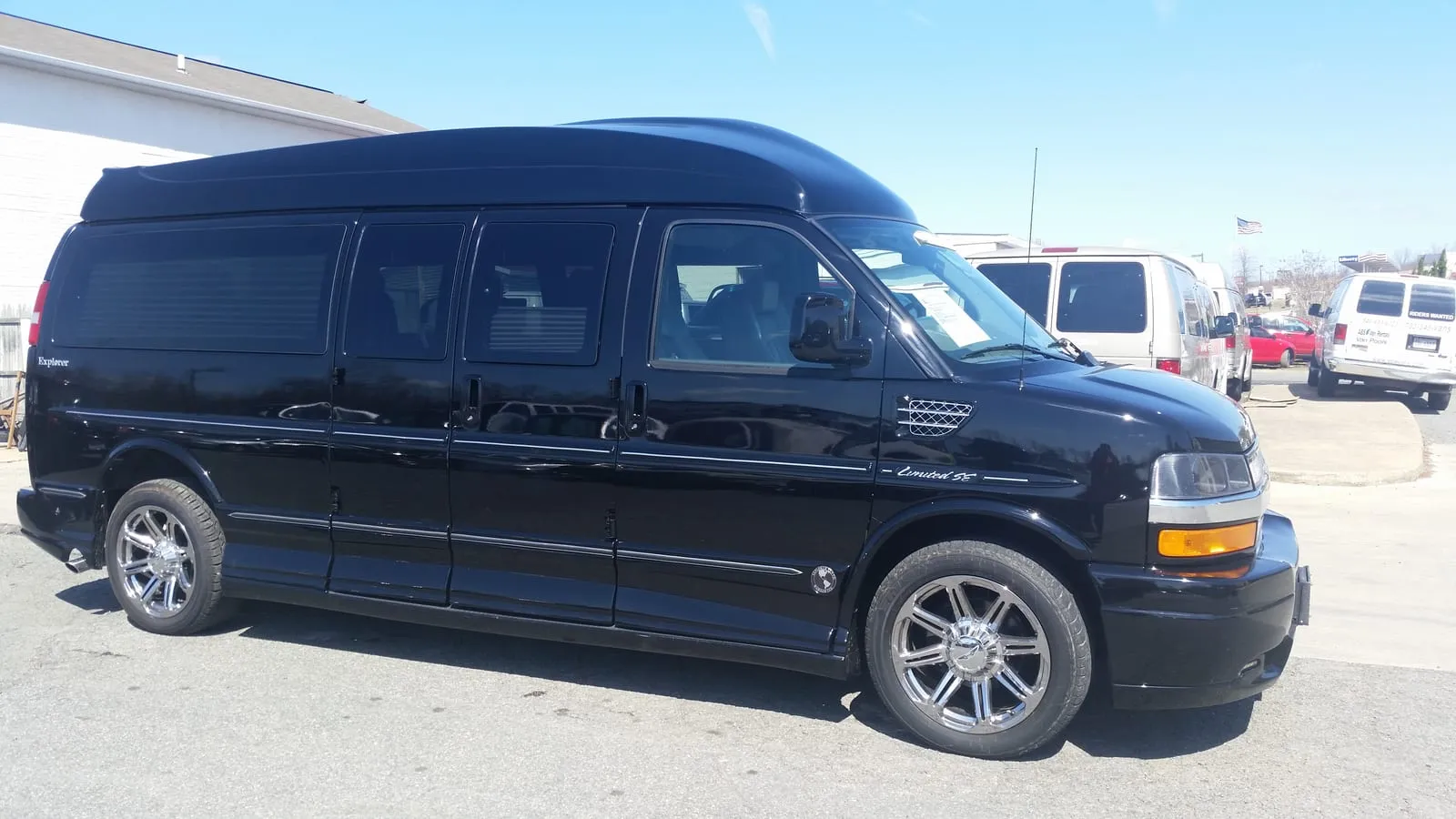 Black 9-passenger Chevrolet Express luxury conversion van with a raised roof